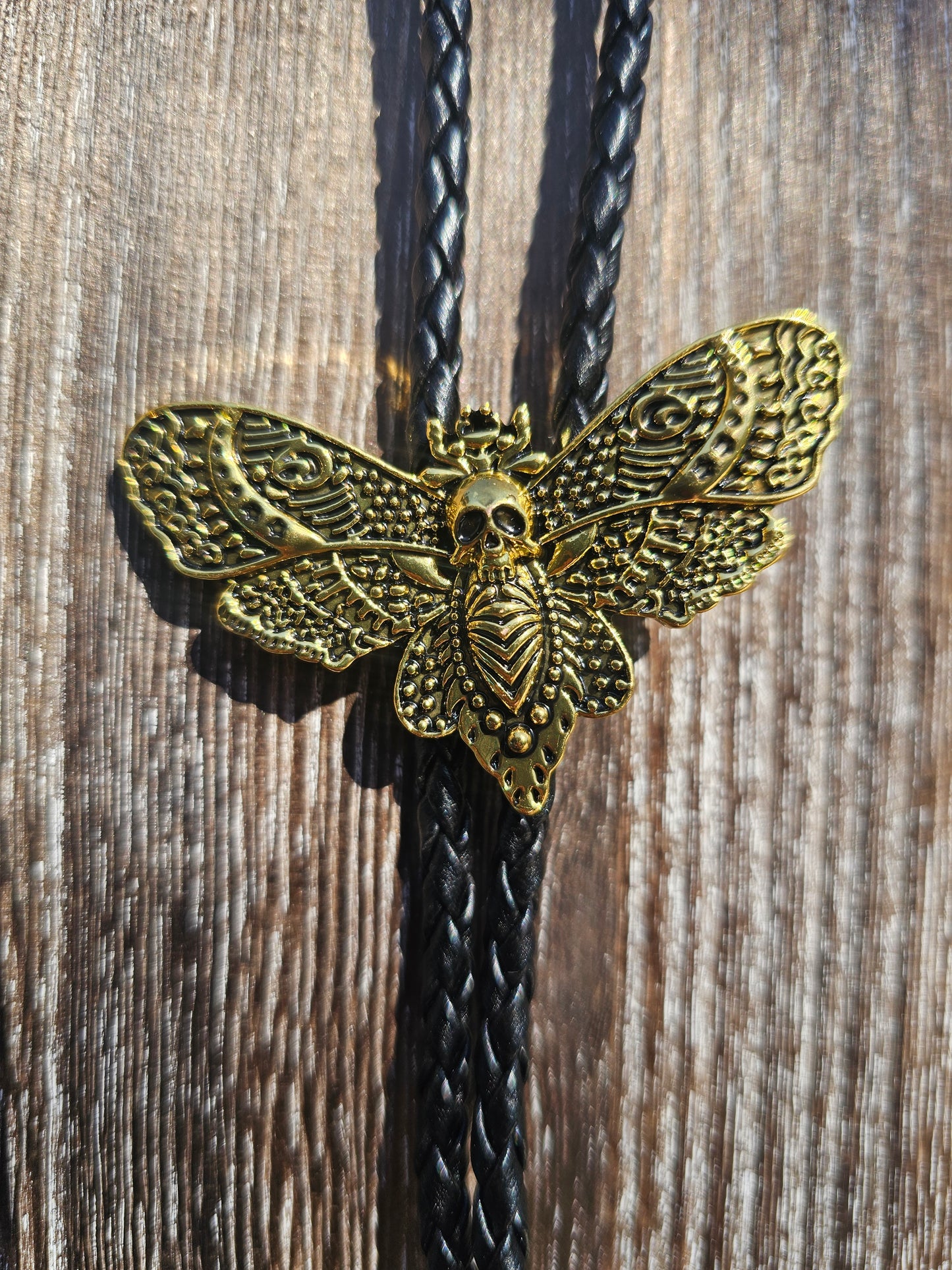 Golden dead head skull moth bolo tie