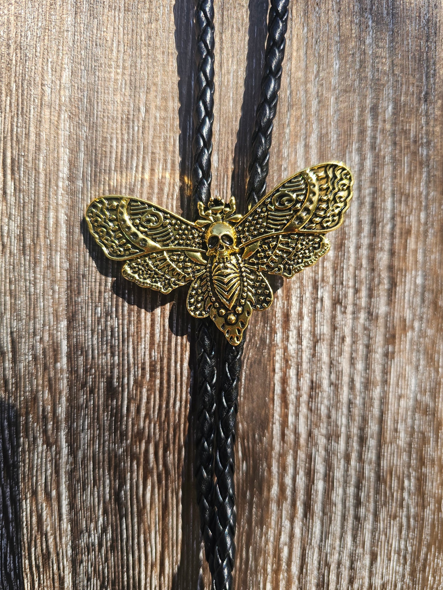 Golden dead head skull moth bolo tie