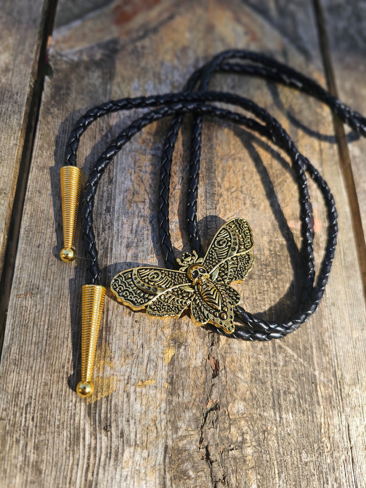 Golden dead head skull moth bolo tie